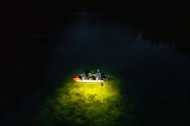 Romantic light tour by glass kayak on Lake Äntu Sinijärv at night.